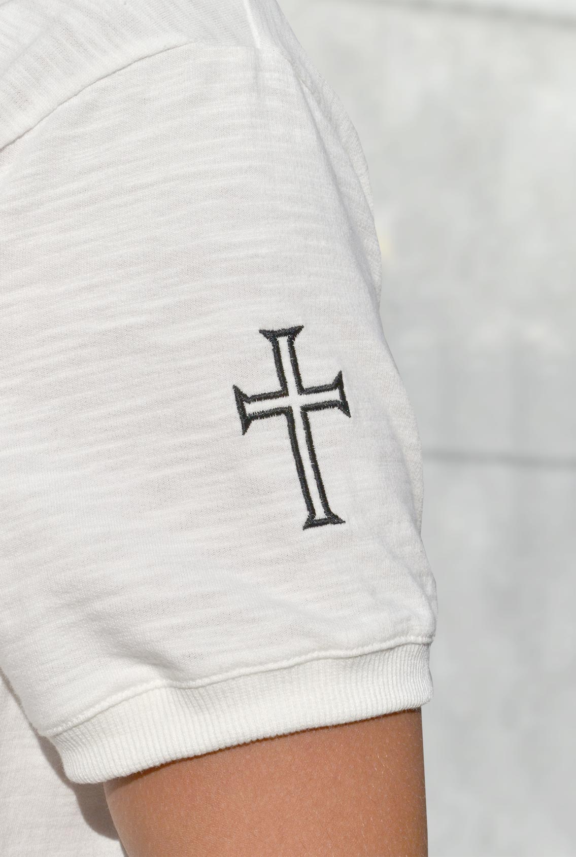 Cross on t-shirt sleeve